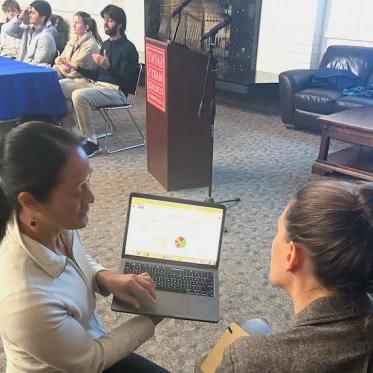 women showing something on the laptop